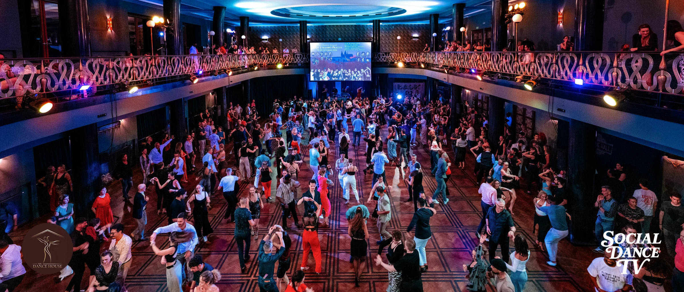 Social dancers fill the dancefloor at Back 2 Mambo 2025, seen from the balcony.